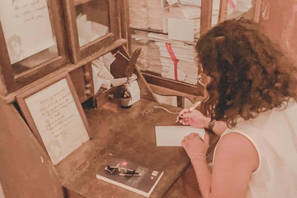 Writing an anonymous letter at the Undelivered Project Installation inside Pinto Art Museum