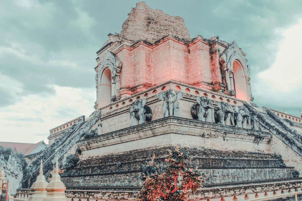 The partially ruined chedi of Wat Chedi Luang with elephant sculptures along its base, a historic Chiang Mai tourist spot in the Old City