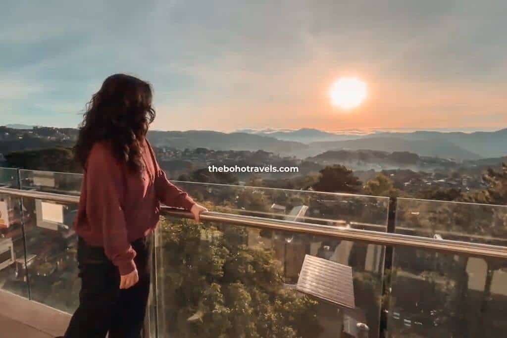 A Baguio tourist enjoying the mountain view, one of the best things to do in Baguio