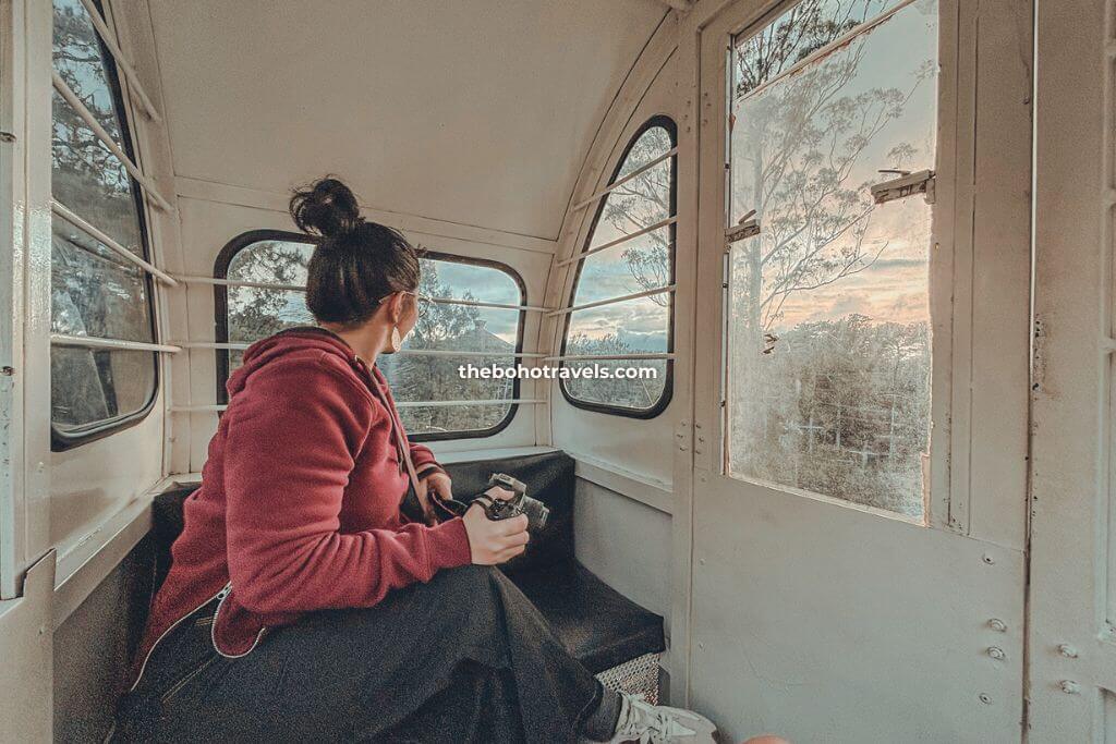 A girl on a ferris wheel looking at the scenic mountain view of Baguio City, one of the best things to do in Baguio
