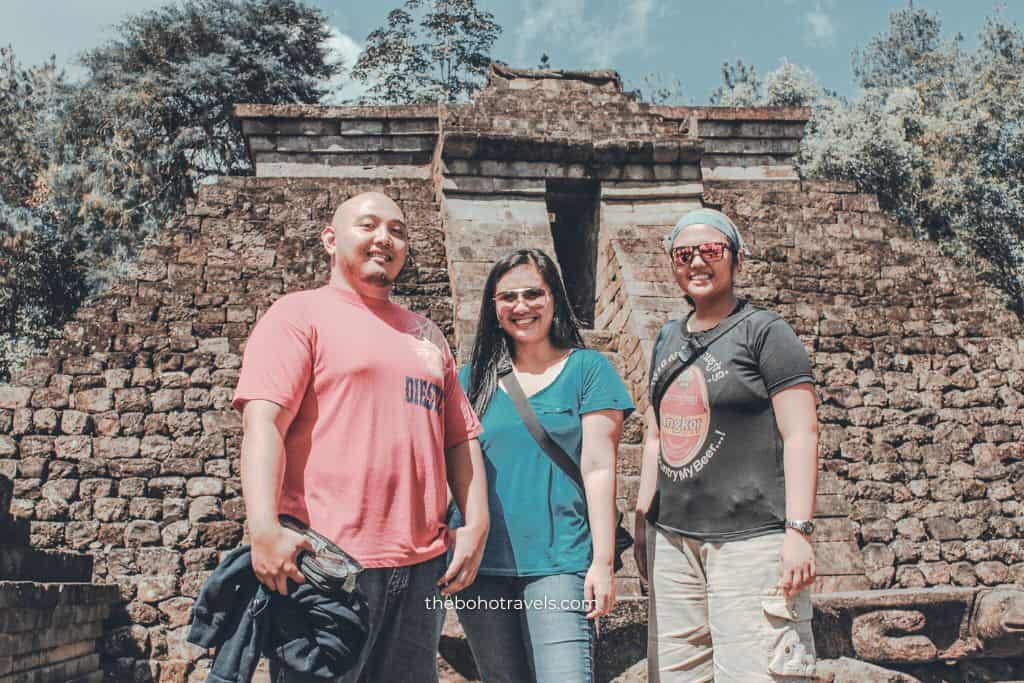 Three travelers in Sukuh Temple, answering the question, Is Candi Sukuh worth visiting?