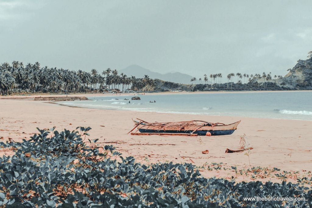 Boat at Nacpan Beach. Visiting it is one of the best things to do in El Nido