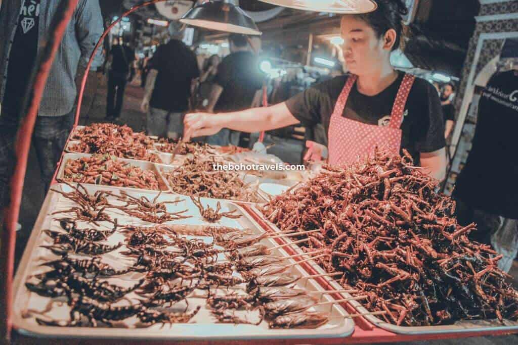 woman selling fried insects at Khao San Road. Experiencing eating these is one of the top things to do in Bangkok