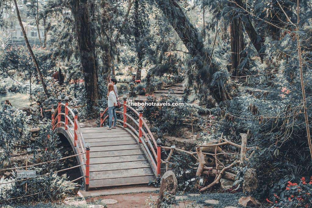 A couple on a bridge of Baguio Botanical Garden, one of the top tourist spots in Baguio first-timers should visit