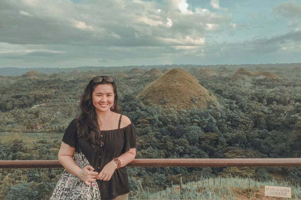 A woman with the background of the Chocolate Hills in Carmen, Bohol